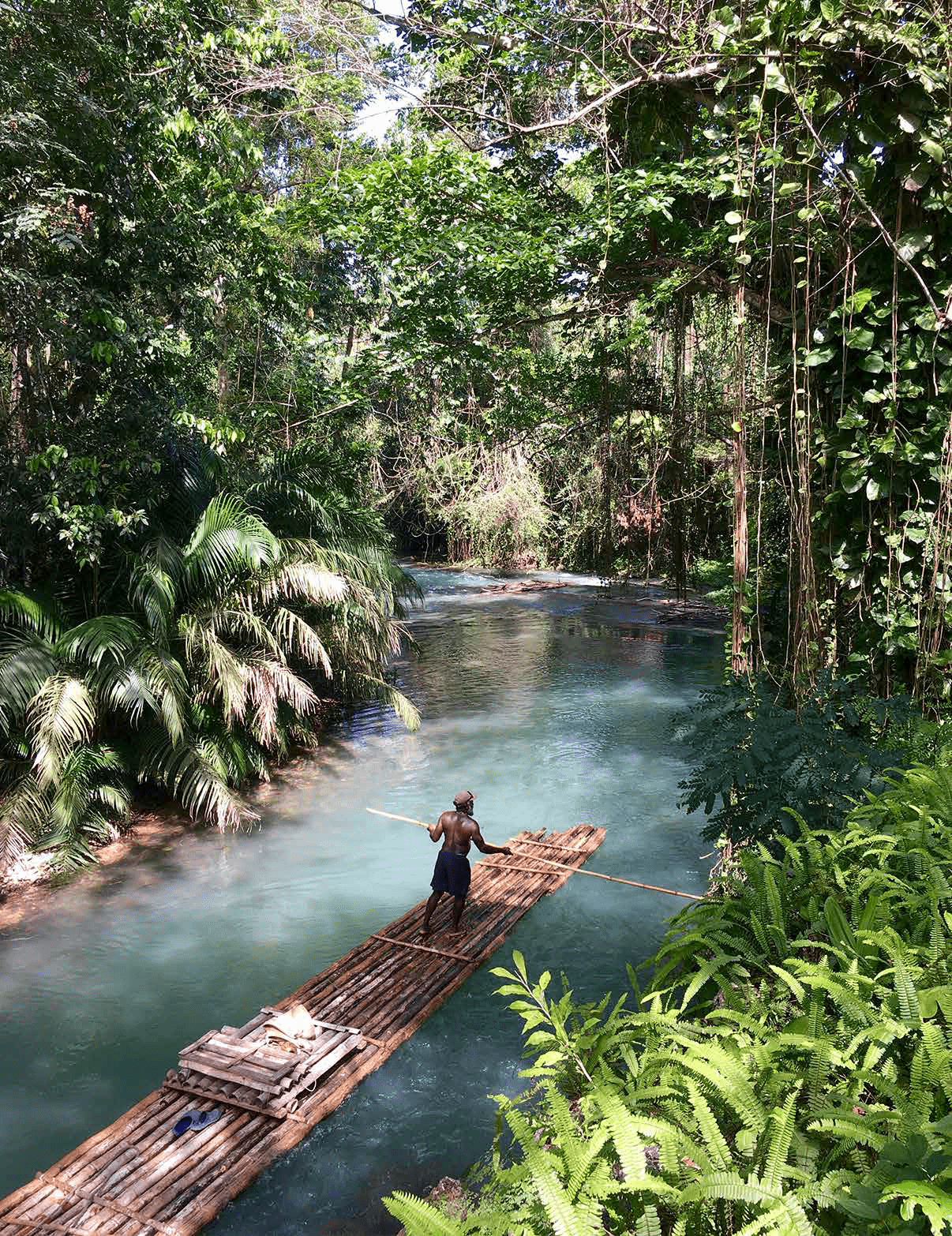 A man is standing on a wooden raft in a river, holding a paddle. AI generated content