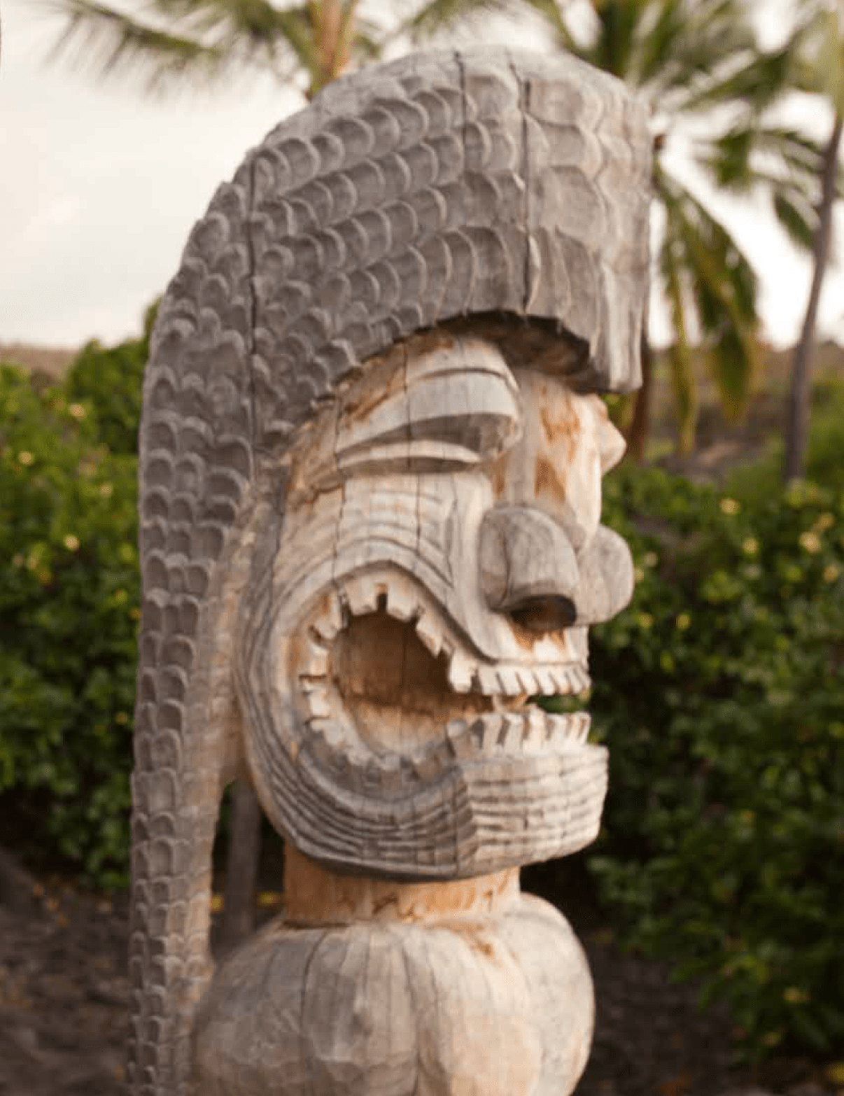 A wooden carving of a face with a big smile. Description generated by AI